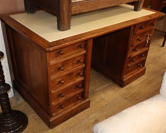 A 20th century mahogany pedestal desk, fitted ten small drawers, with side locking plates W.140cm